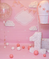 Photo zone with paper garlands, balloons, paper honeycombs, paper balls, pom poms, confetti and cream cake. Birthday cake. Smash cake. One year. Blue, brown, gold, beige, turquoise colors.