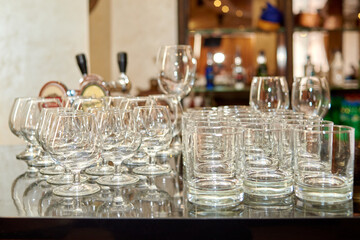 Clean sparkling wineglasses on table in bar, copy space