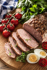Homemade ground meatloaf with eggs tomatoes celery herbs and thyme