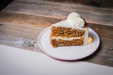 delicious vanilla cake on wooden table, in cafe
