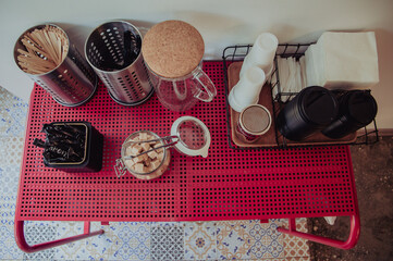 Espresso bar equipment on red table, top view