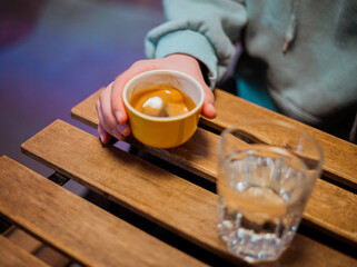 Espresso cup in hand on the table, in cafe