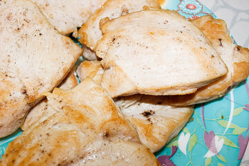 Fried delicious pieces of chicken fillet lie on a plate.