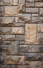 Ancient brick stone wall. Antique brickwork with stones of different sizes. Close up shot. Abstract texture or background.