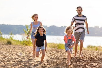 Young family enjoying time at the beach 
