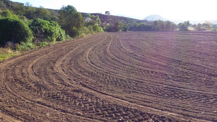 Obraz na płótnie Canvas Tractor Tracks and Grooves in a Freshly Tilled Field of Dark Soil, Little Karoo South Africa