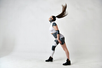 beautiful brunette girl in a robot suit posing on a white background