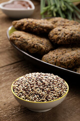 Gluten free and vegetarian quinoa hamburgers on a wooden table.