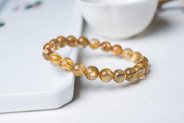 gem bracelet in front of white background 

