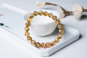 gem bracelet in front of white background 
