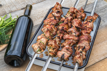 Pork skewers put on the grill in the garden of country house.