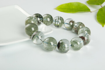 gem bracelet in front of white background 
