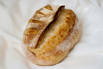 Sourdough bread. Baked homemade sourdough bread on white surface