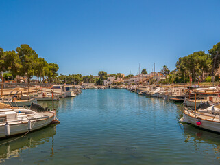Fototapeta na wymiar Porta Petro Mallorca Spain marina harbour with traditional fishing boats and pleasure craft moored