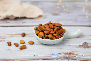 Pine nuts on wood background