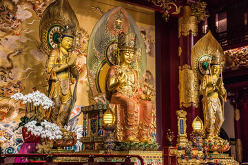 Fototapeta na wymiar Altar in the Buddha Tooth Relic Temple and Museum, Chinatown, Singapore