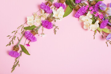 Fototapeta na wymiar summer flowers on pink paper background