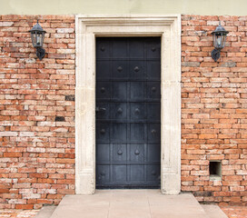 Fototapeta na wymiar Old metal door of an old brick house