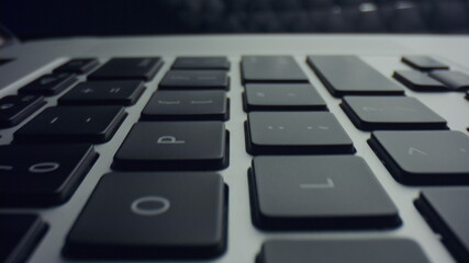 Grey laptop computer with black keyboard. Modern black keyboard of laptop
