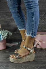 Woman posing in stylish summer footware. Beauty and Fashion concept