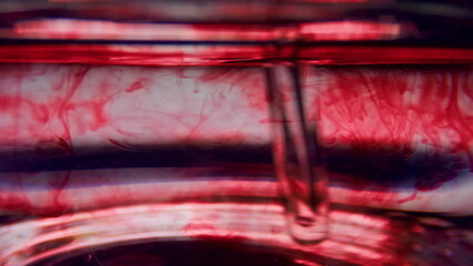 Macro of test tube with blood. Stirring red liquid in glassware with pipette