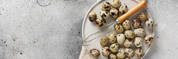 Quail eggs in a white plate on the kitchen table. Quail eggs m Corolla on a culinary background....