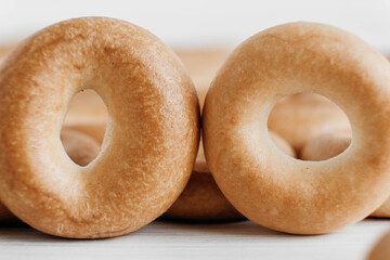 Drying or mini round bagels on a white wooden background. Copy, empty space for text