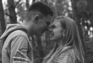 Couple leaned against each other noses black and white photo