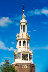 Fototapeta na wymiar Clock tower in Amsterdam, the capital of the Kingdom of Netherlands