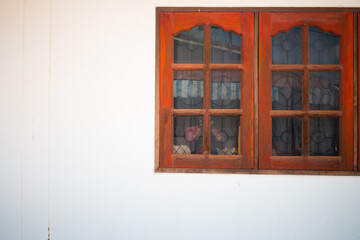 old wooden window with shutters on the bright whtie wall background
