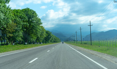 Fototapeta na wymiar Auto road leading to the mountains