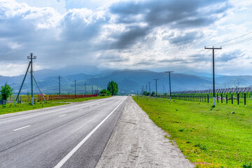 Fototapeta na wymiar Auto road leading to the mountains