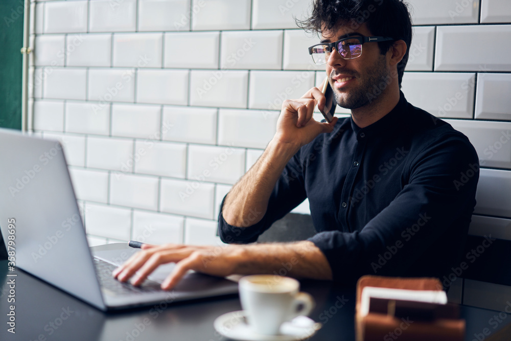 Poster positive young it professional in eyeglasses searching information in internet for personal website 