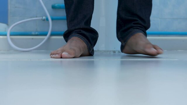 Young man took off his pants and sat on the toilet.