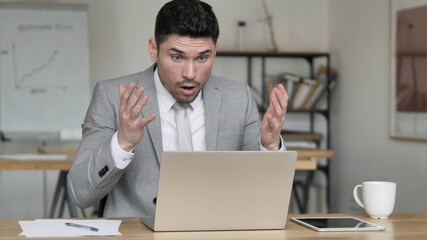 Online Video Chat at Work by Businessman