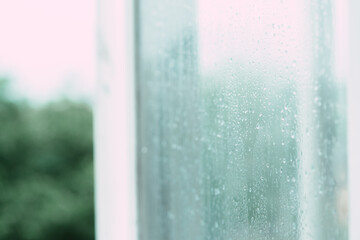 Raindrops on a foggy open window