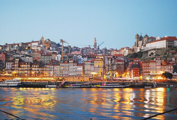 Downtown Porto city lights and Douro river during twilight seen from Vila Nova de Gaia, Portugal