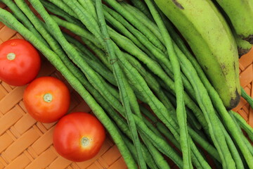 Green beans display with selective focus and fresh various raw organic vegetables for healthy and diet background.
