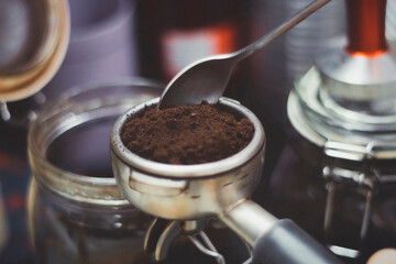 Making espresso with freshly ground coffee and machine