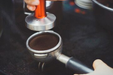 Making espresso with freshly ground coffee and machine