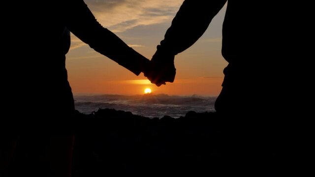 Dramatic break up Couple separating their hands at sunset, love story ending, family break-up at valentines day,closeup