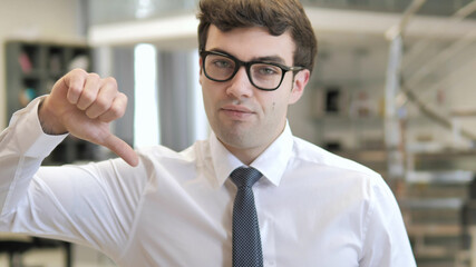 Thumbs Down by Young Businessman