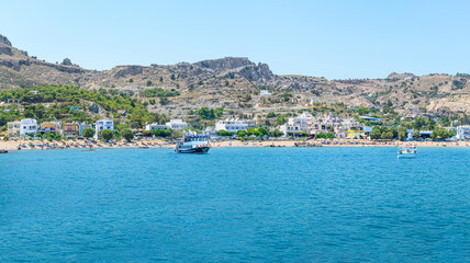 Fototapeta na wymiar Panoramic view of Stegna beach with anchored tourist boats (RHODES, GREECE)