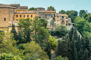 Fototapeta na wymiar Residential houses of the old town built on a steep slope in a popular hilltop town of Volterra, Tuscany, Italy, seen from Piazza XX Settembre.