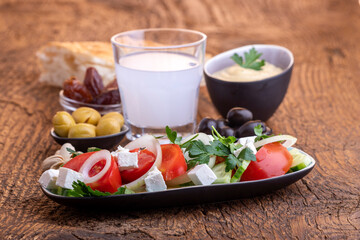 olives and hummus on dark wood