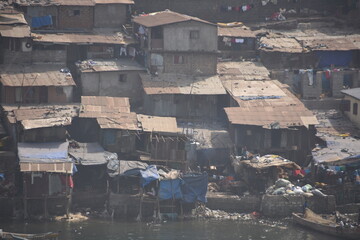 Shanty town in Freetown in Sierra Leone. Demolished and poor houses in the suburb of  capital city. View from container ship berthed in port in container terminal port.
