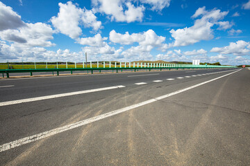 Empty highway, blue sky and white clouds landscape