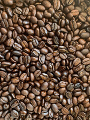 Close-up of freshly roasted coffee beans The fragrance is seductive, refreshing, and dark brown. It can be used to assemble print media, advertisements, print packages of the cafe.