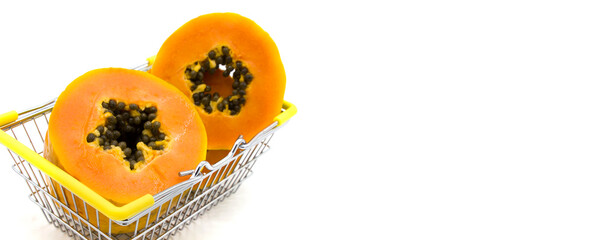 Papaya. Juicy ripe papaya in a mini basket for shopping isolated on a white background close-up. Concept of a healthy diet and detox. Fresh fruit delivery Online shopping concept. Space for text. 