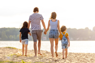 Young family enjoying time at the beach 

